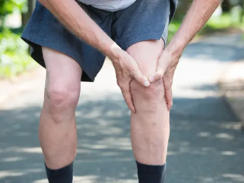 Physical therapist assessing a patient's knee stability and ACL function