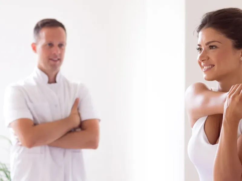 Physical therapist guiding a patient through gentle, low-impact movement for fibromyalgia