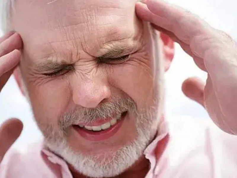 Physical therapist assessing a patient's upper neck mobility related to headaches