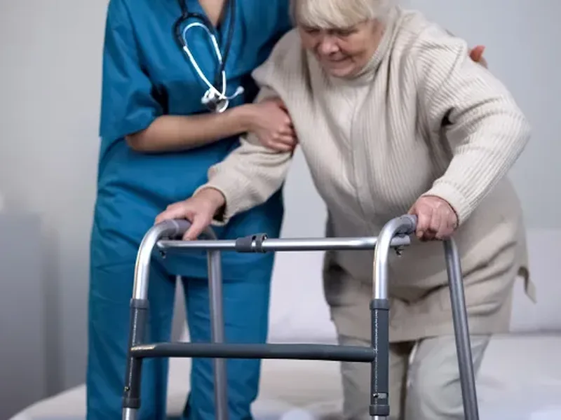 Physical therapist guiding a patient through post-surgical hip replacement rehab exercises