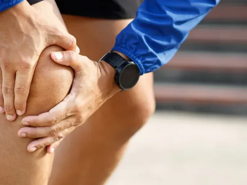 Physical therapist assessing a patient's joint mobility and movement pattern