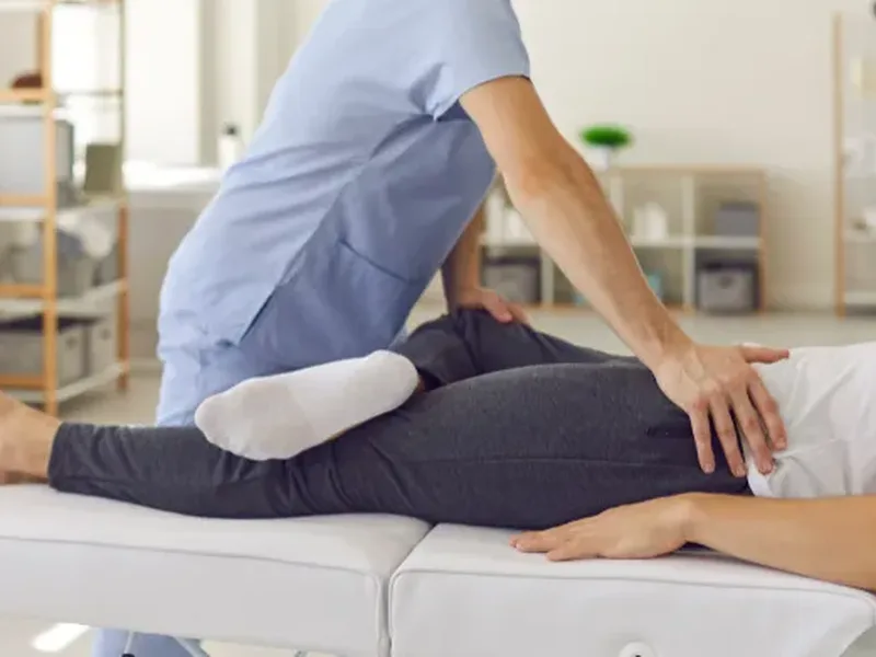 Physical therapist assessing a patient's neck mobility after a car accident