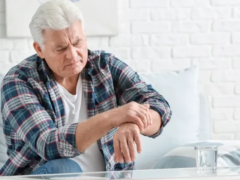 Physical therapist guiding a patient through a balance and gait exercise for Parkinson's disease