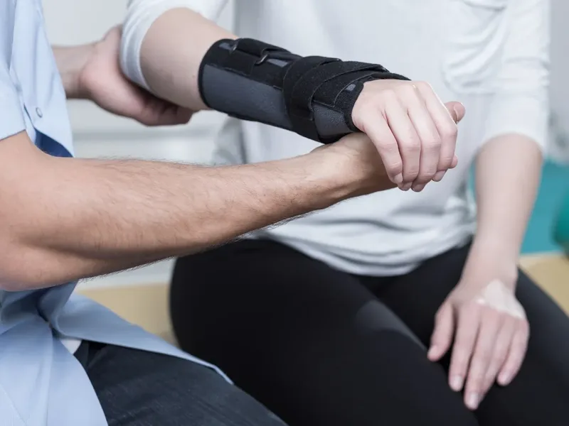 Physical therapist guiding a patient through a post-surgical rehabilitation exercise