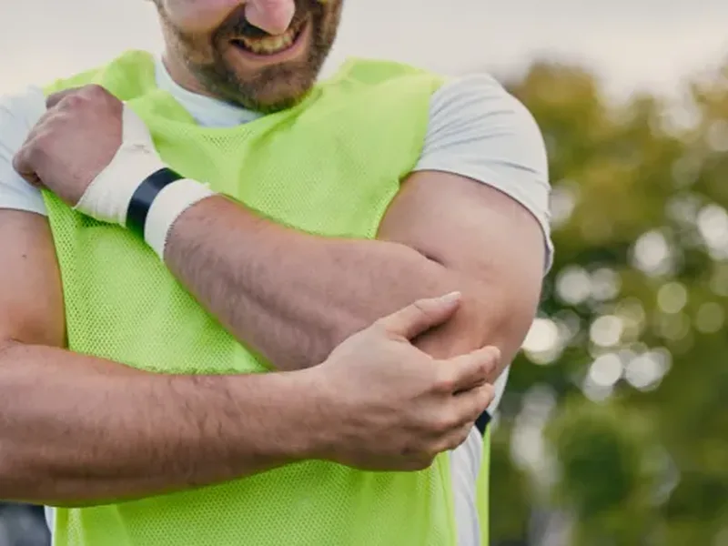 Physical therapist assessing tendon movement and strength during an evaluation
